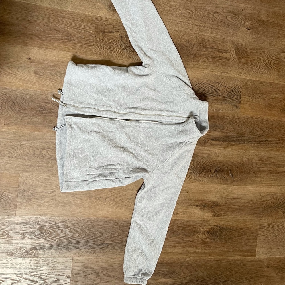 100% polyester, light grey/silver. Lightly worn